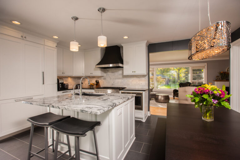 Freshly painted white kitchen cabinets with marble island in a modern Saint Paul residential home interior painting project