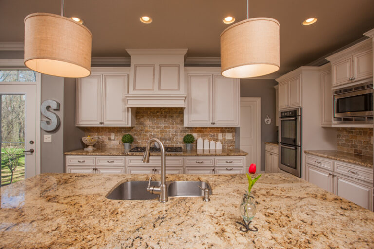 Residential kitchen after cabinet painting, white glazed cabinets, granite island, brick backsplash, Saint Paul home interior