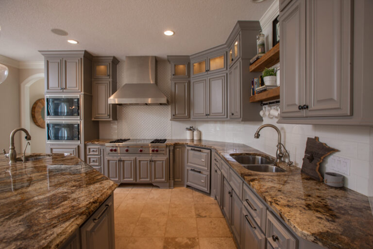 Residential kitchen cabinet painting in gray with granite countertops and stainless hood, Saint Paul, MN home interior