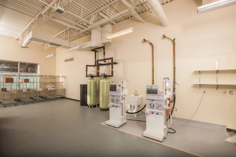 Interior painting of a medical facility in Saint Paul, MN, featuring cream walls, dialysis equipment, and exposed ceiling ...