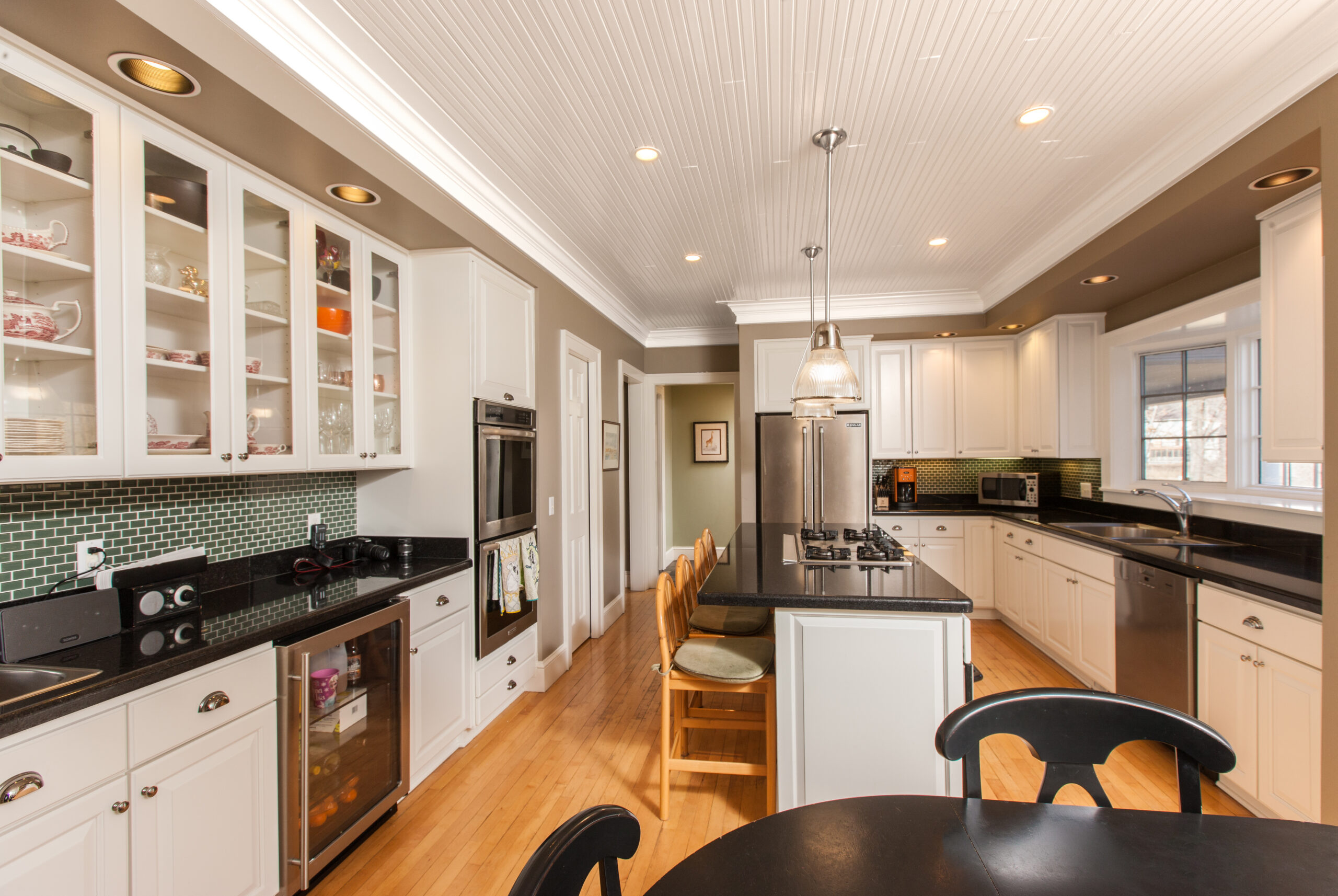 Kitchen with freshly painted taupe walls, white cabinetry, and a white beadboard ceiling.