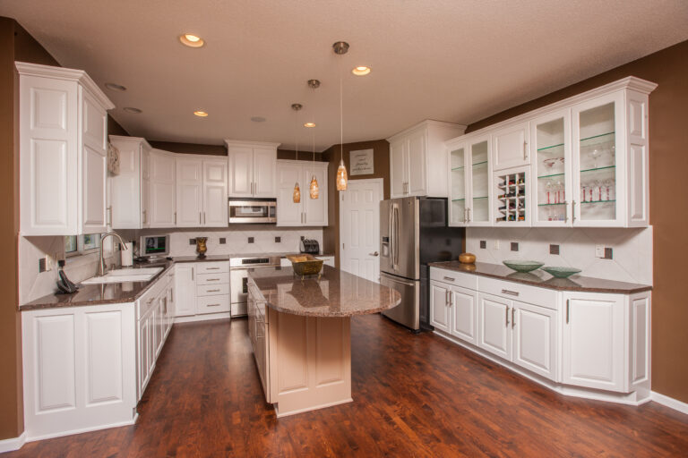 White painted kitchen cabinets with dark granite countertops and hardwood floors. Painted walls and ceiling in Macalister Groveland in St. Paul MN.