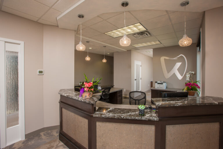 Freshly painted beige walls and white trim in a modern dental office reception area. located in Vadnais heights Minnesota.