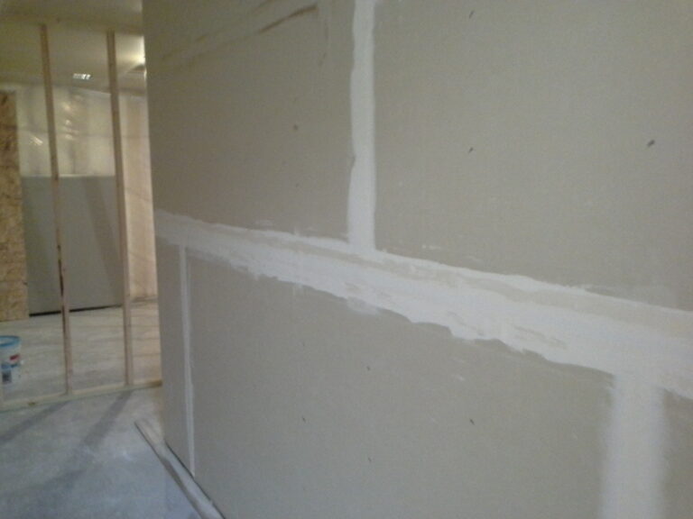 Drywall seams being mudded and taped in an interior room during a construction project. St. Paul MN.