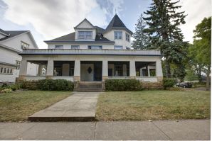 Historic two-story Victorian home in Saint Paul with wraparound porch, ready for exterior painting services.